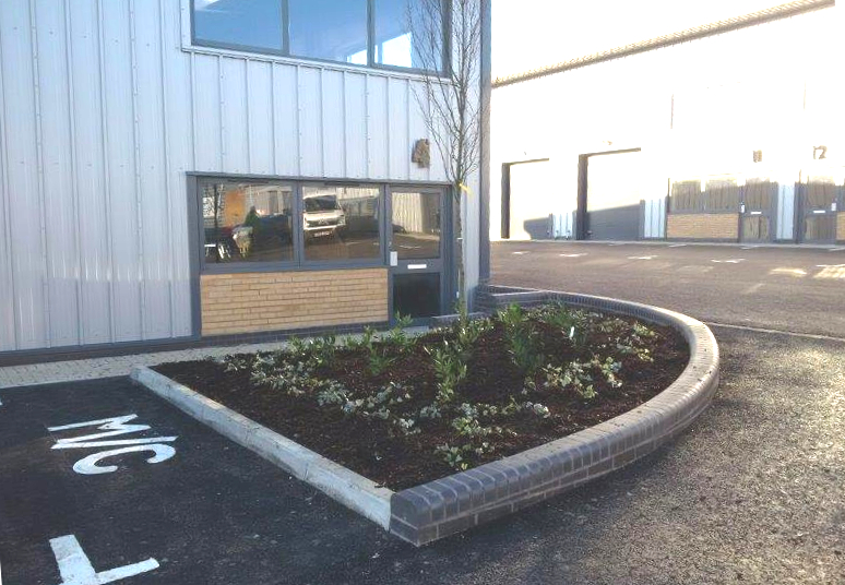 Commercial landscaping with paths, planting and maintained outdoor areas