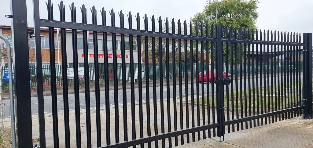 Steel palisade security fencing and gates protecting a commercial industrial entrance